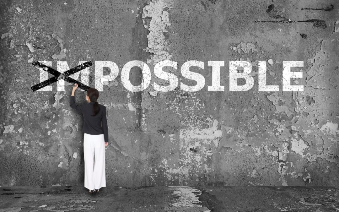 Woman crossing the "im" out of "impossible"