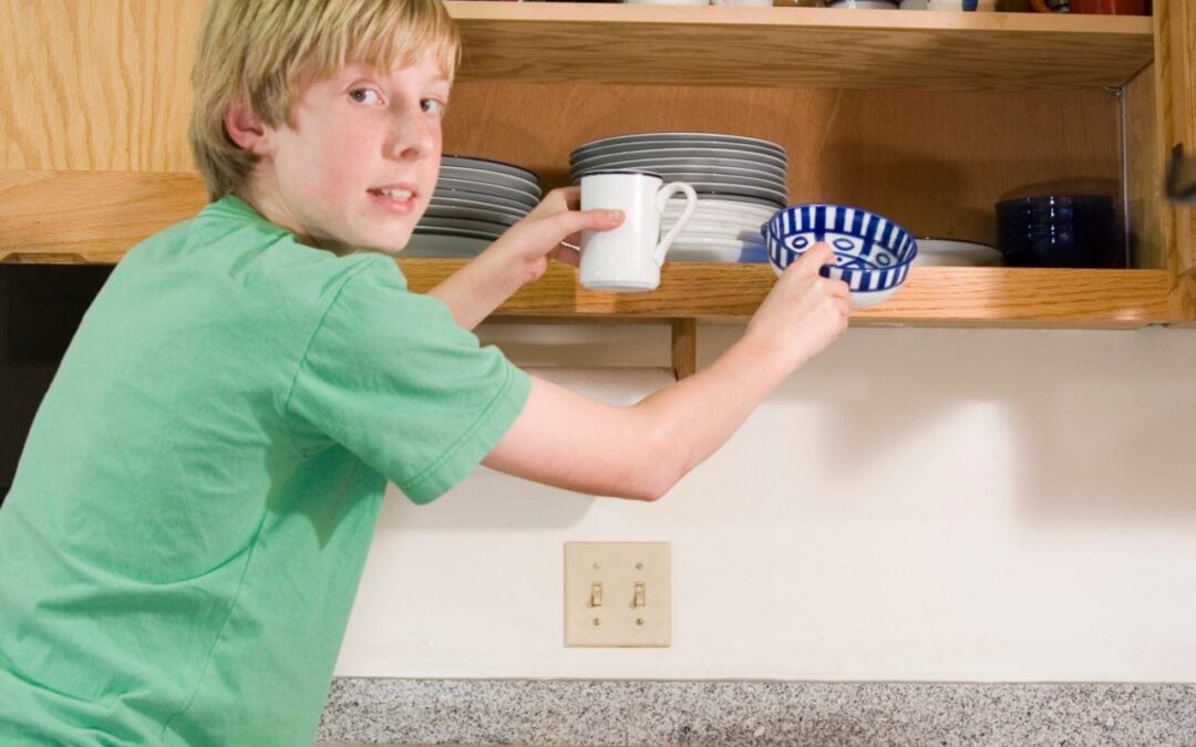 Kid putting dishes away.